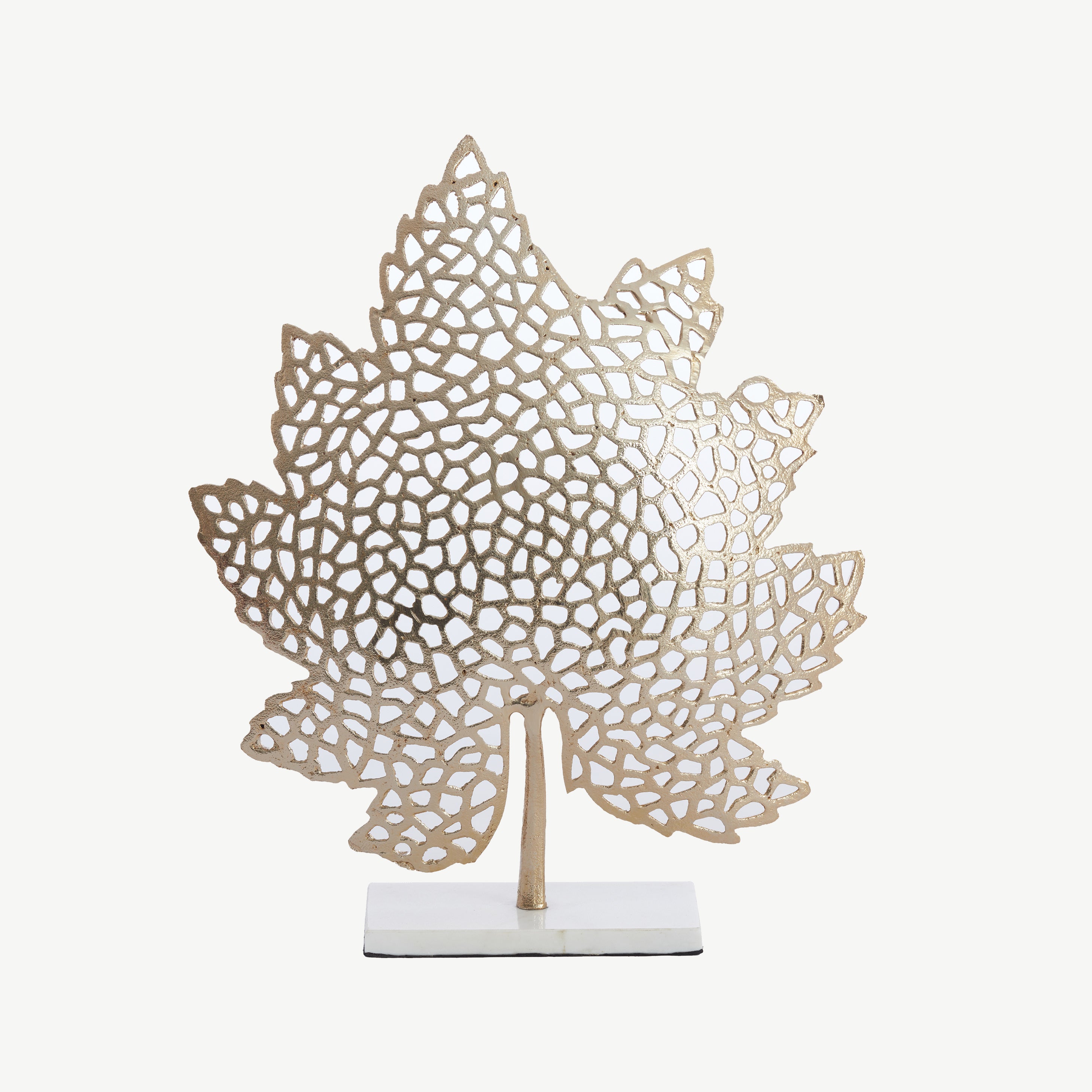 Metal leaf ornament in gold finish with sleek marble base