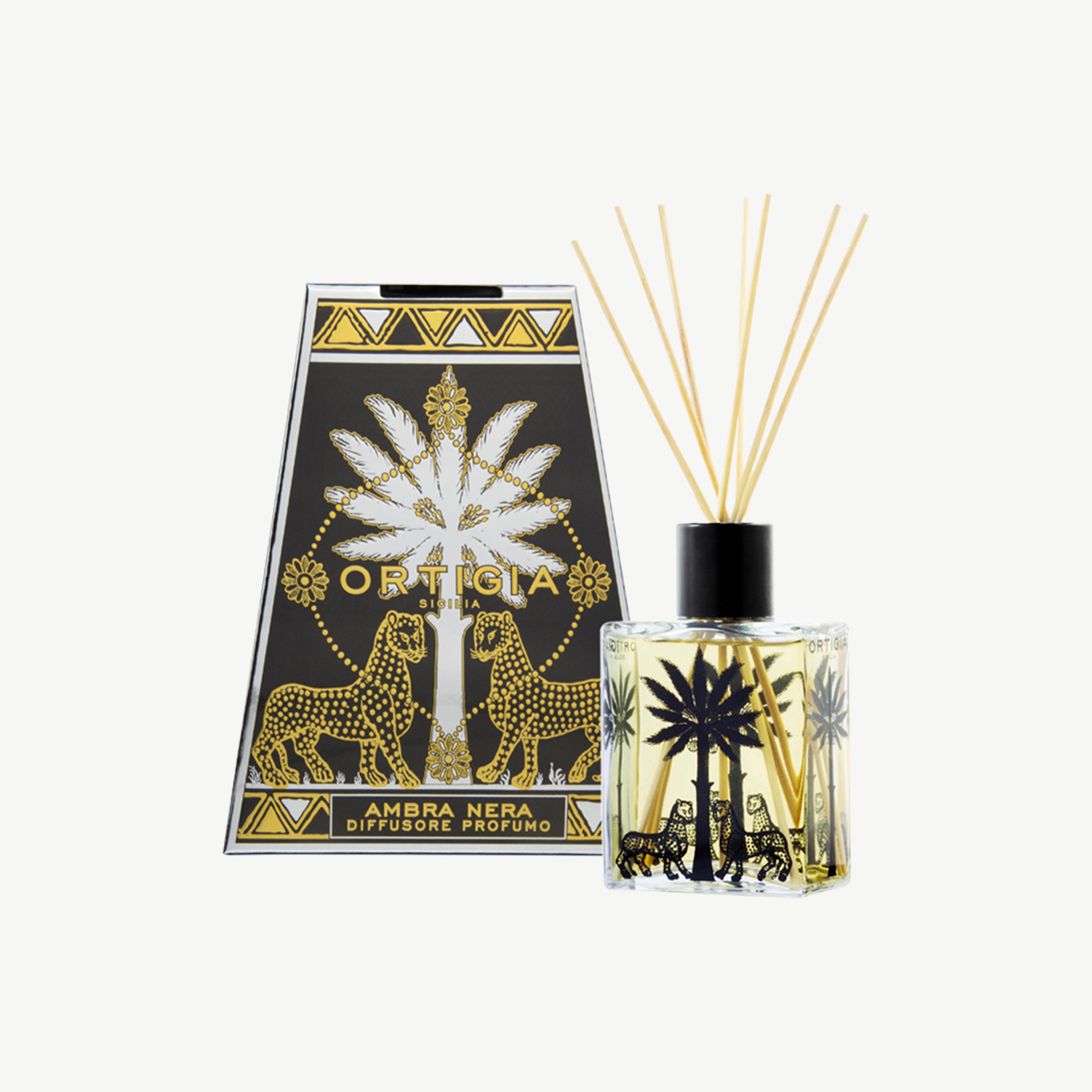 Ortigia amber diffuser in signature yellow tinted bottle with accompanying diffuser sticks