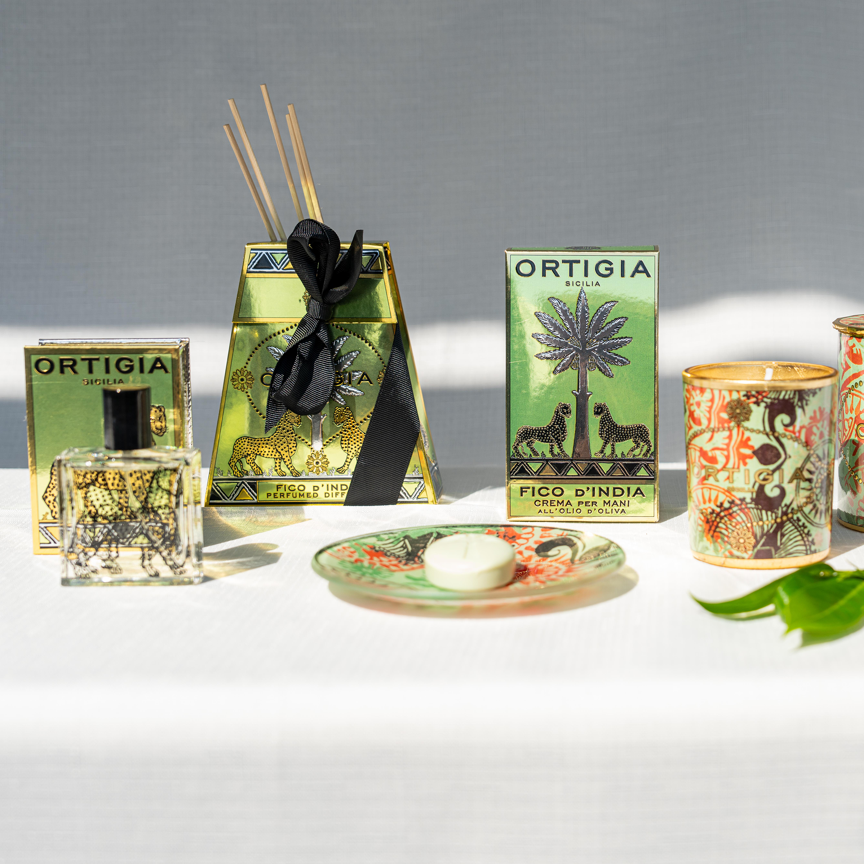 Ortigia Fico dIndia diffuser housed in ornate yellow tinted glass bottle with accompanying diffuser reeds