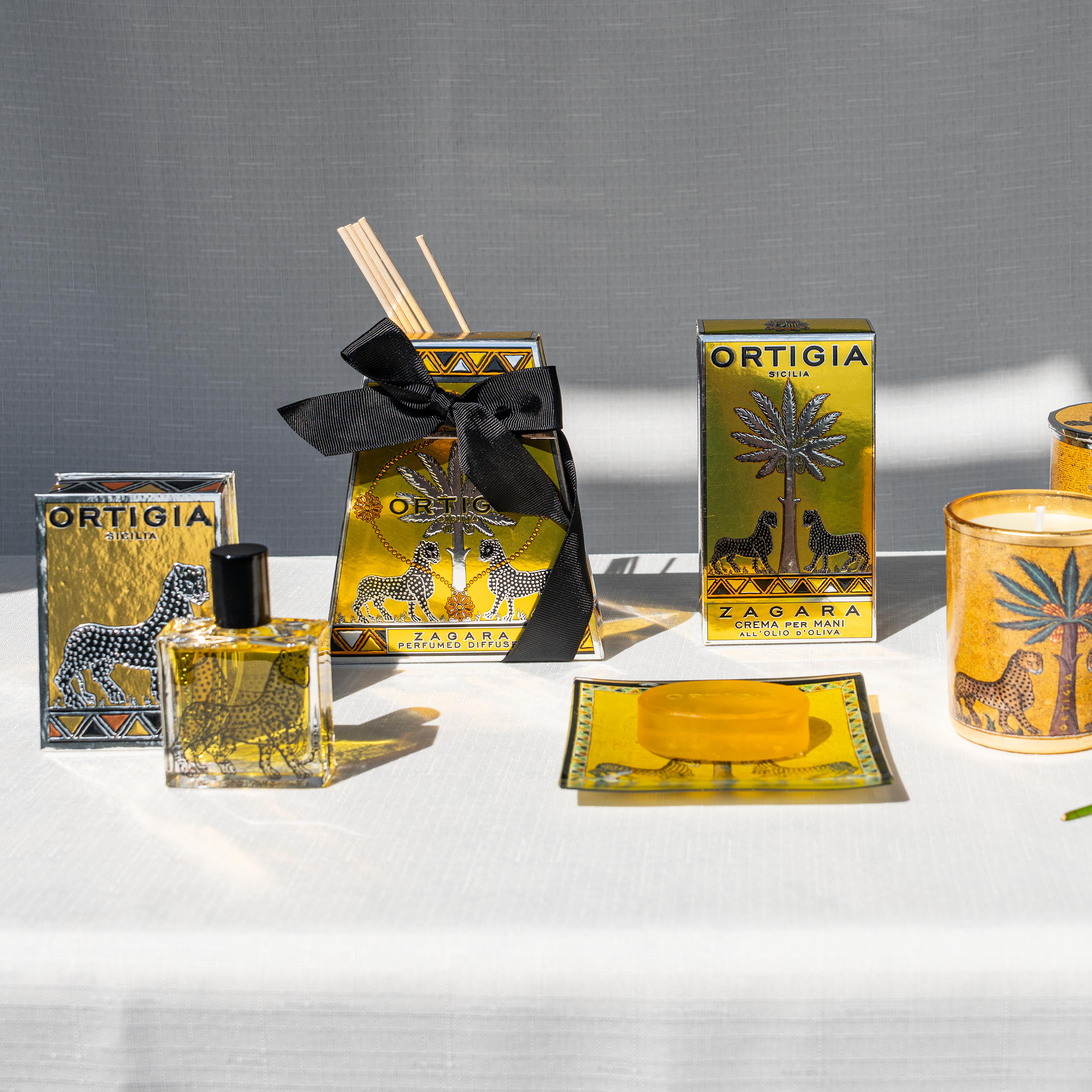 Ortigia Zagara diffuser in signature clear glass printed bottle and accompanying natural diffuser reeds