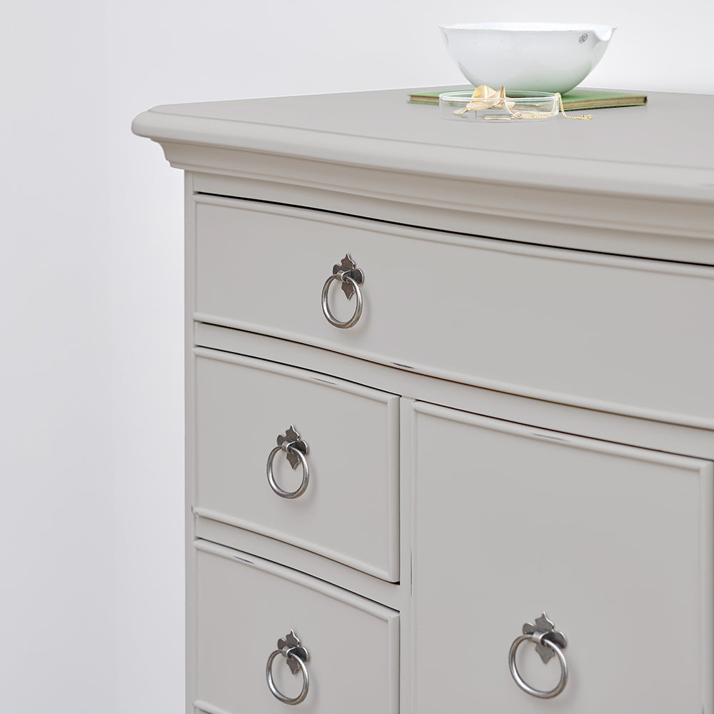 Grey dresser with decorative vase on top