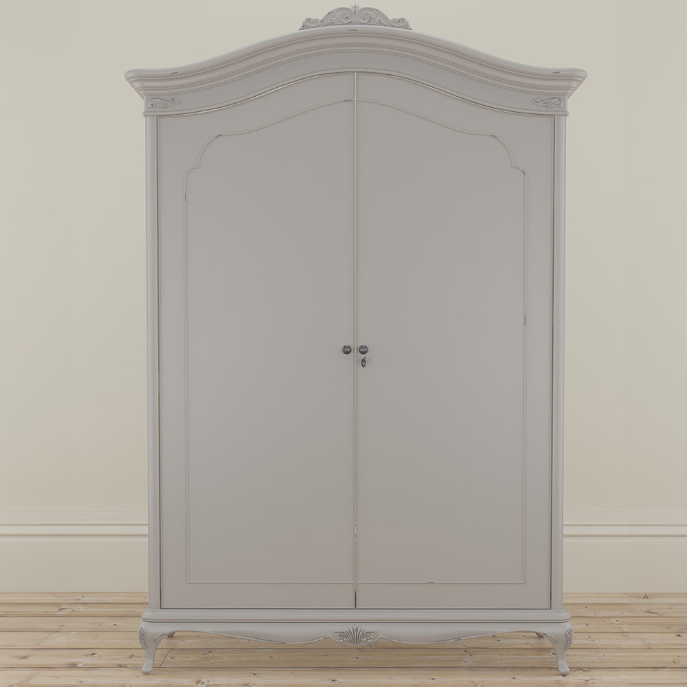 A closed soft grey wardrobe with curved top and ornate crown, featuring double doors and decorative legs