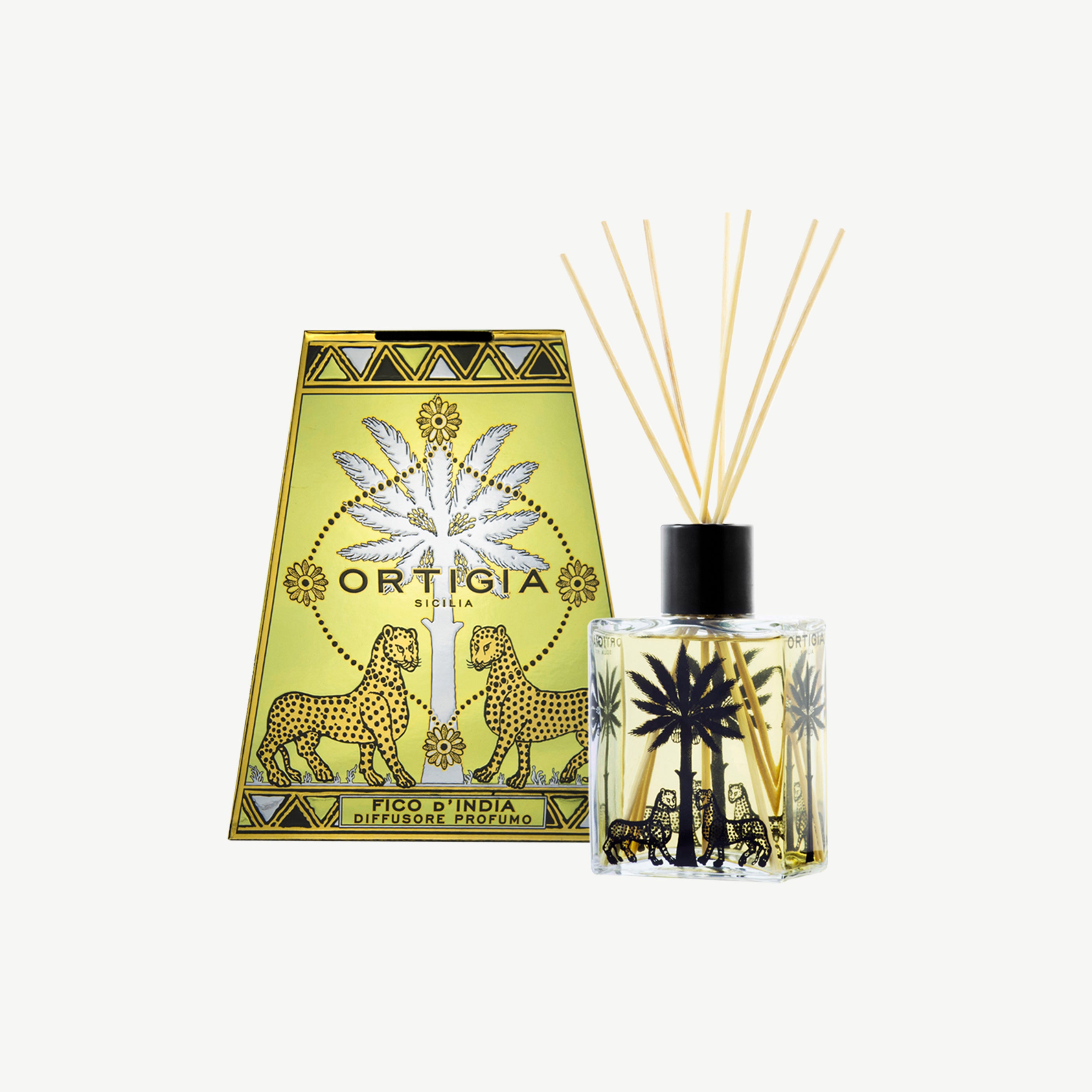 Ortigia Fico dIndia diffuser housed in ornate yellow tinted glass bottle with accompanying diffuser reeds