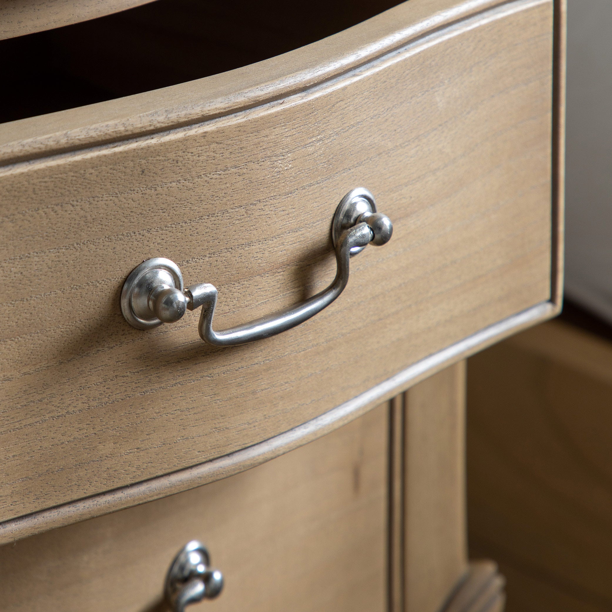 Mindy ash bedside table in weathered finish featuring dovetailed joints and hand carved sections