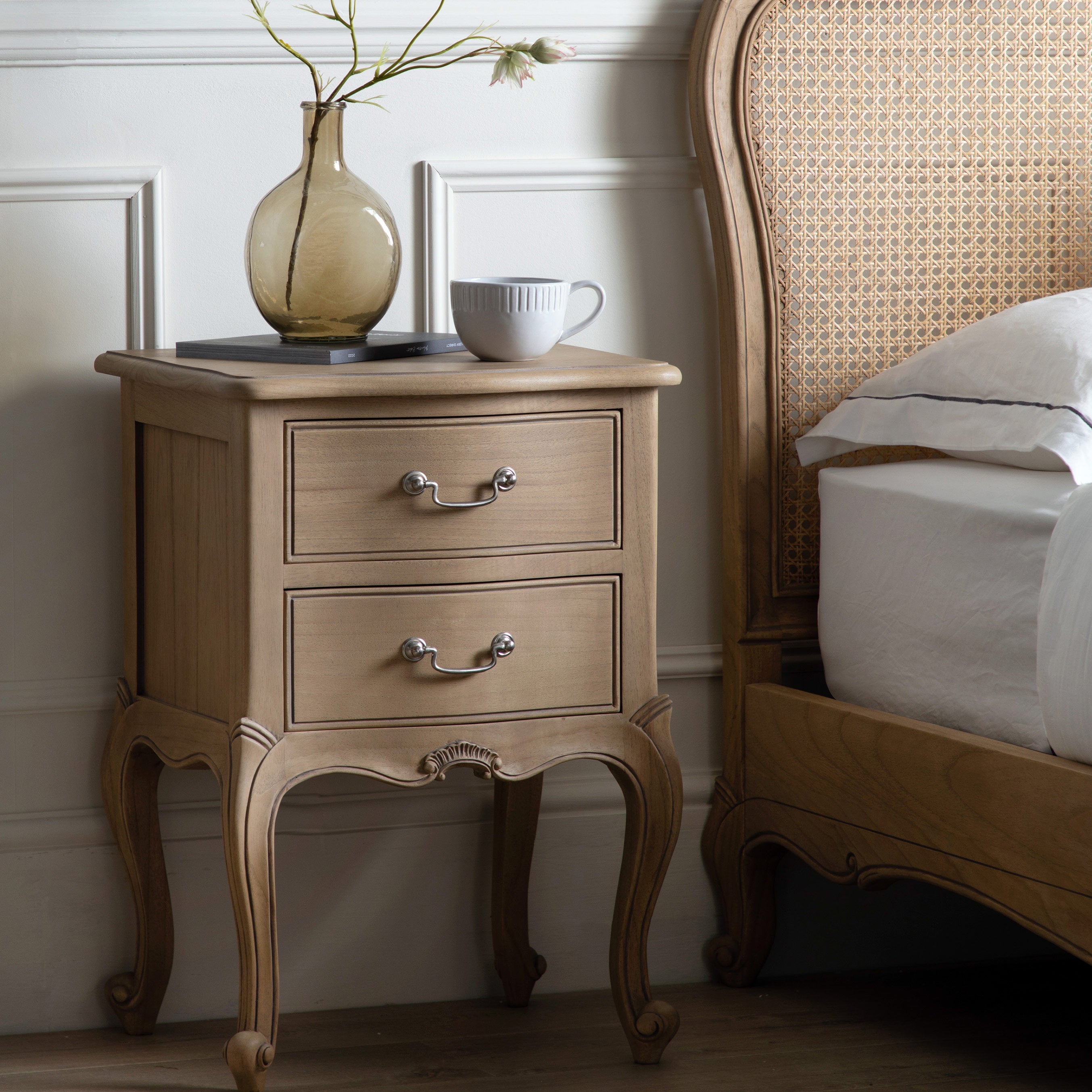Mindy ash bedside table in weathered finish featuring dovetailed joints and hand carved sections