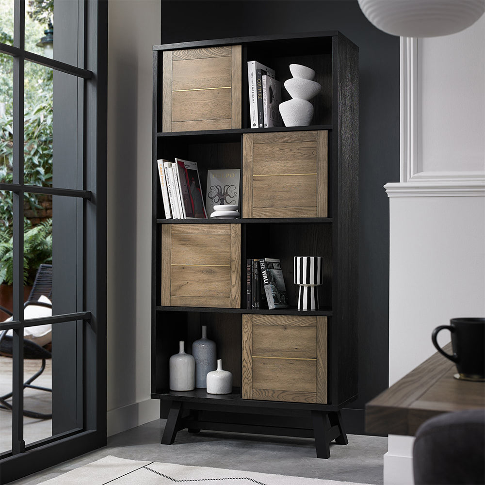 Oak veneer display cabinet with alternating panels and black peppercorn solid ash legs