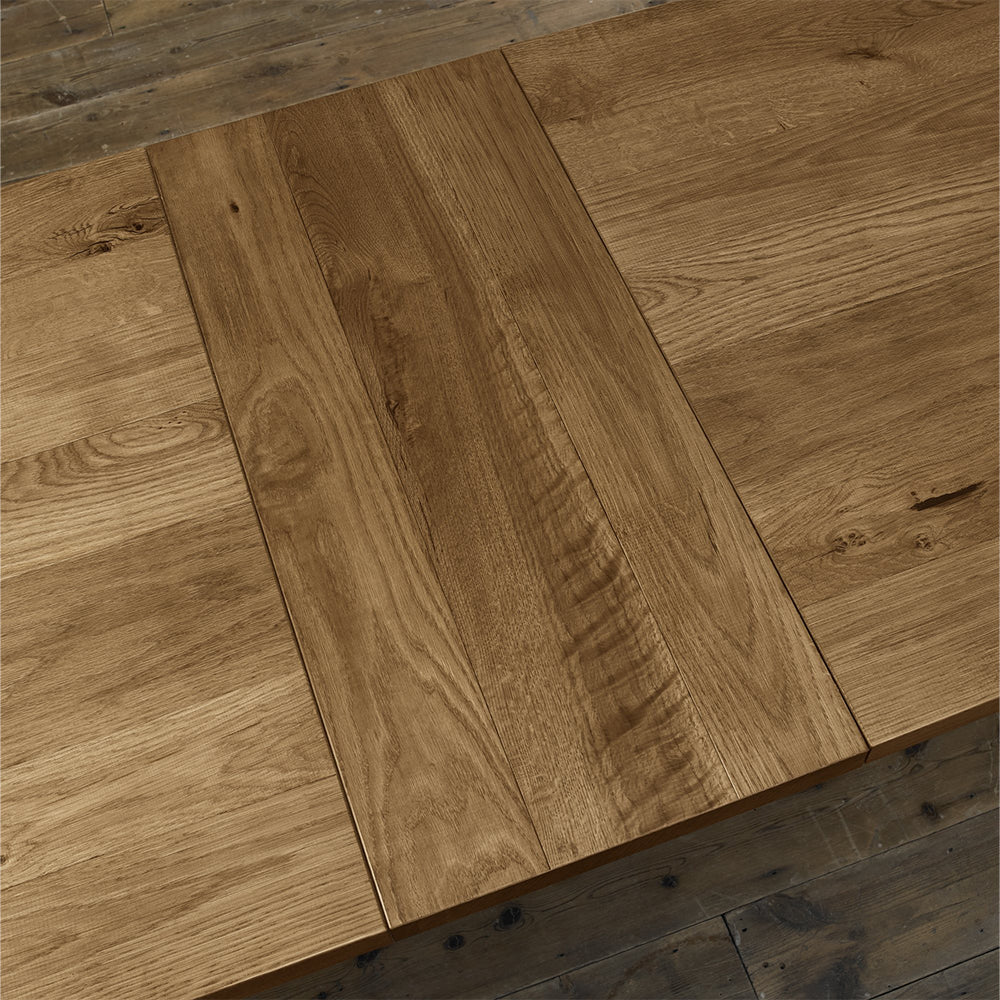 Rustic oak extending dining table with laminated oak tabletops and solid ash legs all in natural finish