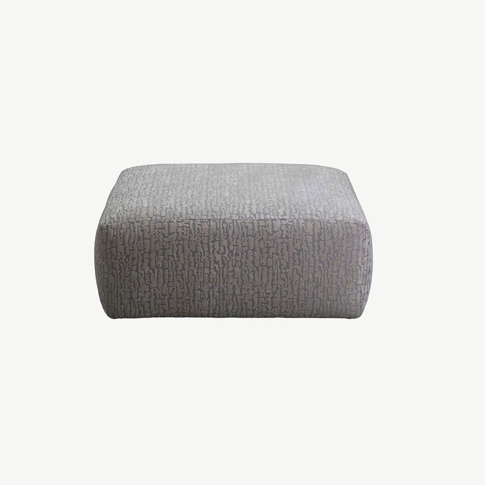 Light grey fabric footstool in geometric design