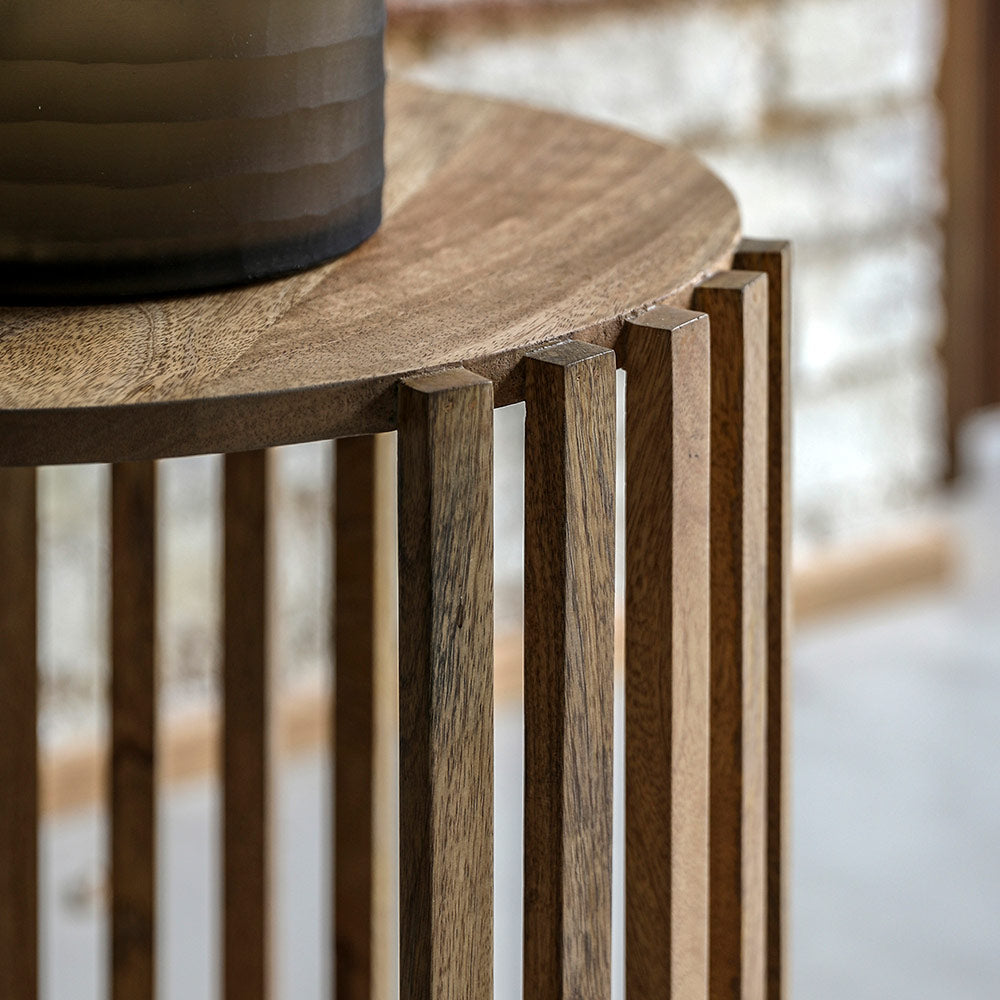 Slatted wooden side table in natural finish with lower storage shelf