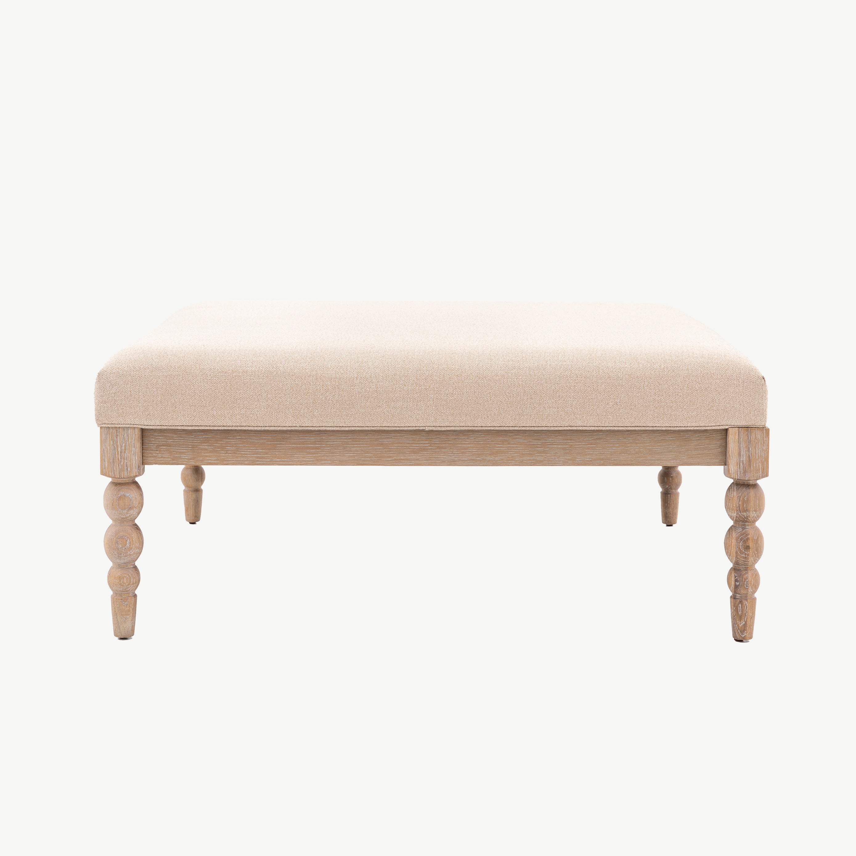 Oak coffee table in lime wash finish, handcrafted bobbing detailed legs and upholstered neutral fabric top