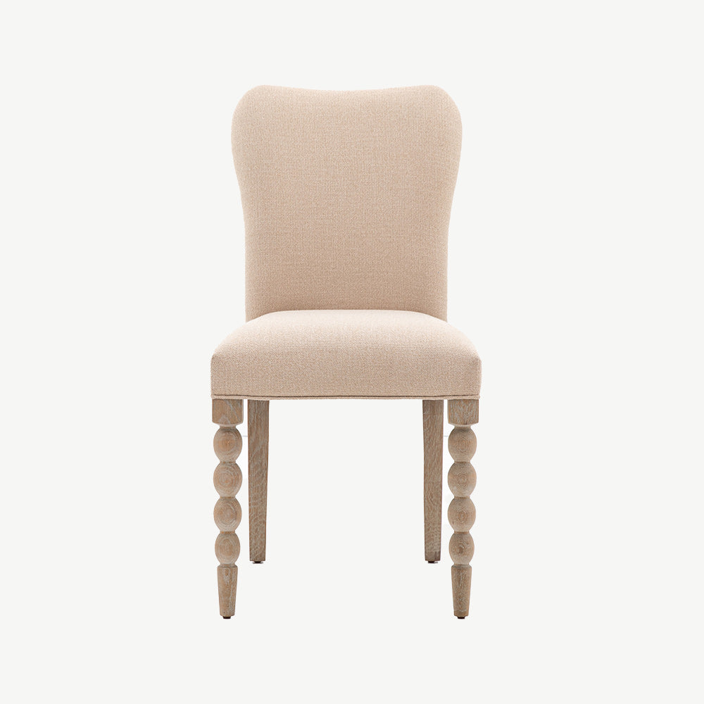 Oak dining chair in lime wash finish, handrafted bobbing detailed legs and upholstered neutral fabric seat