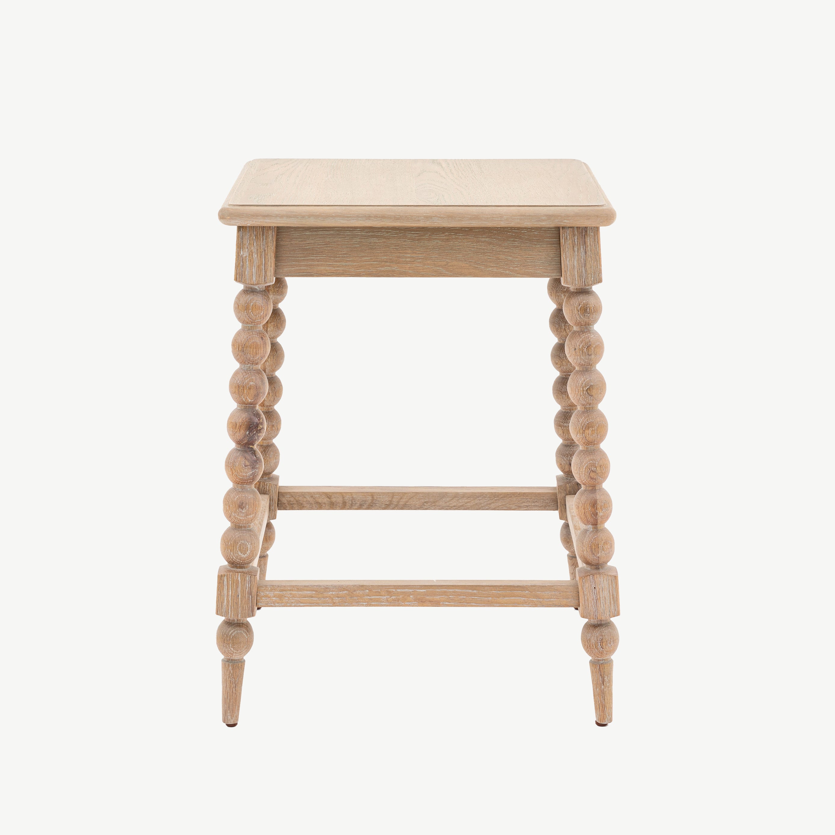 Oak side table in lime wash finish and hancrafted bobbing detailed legs