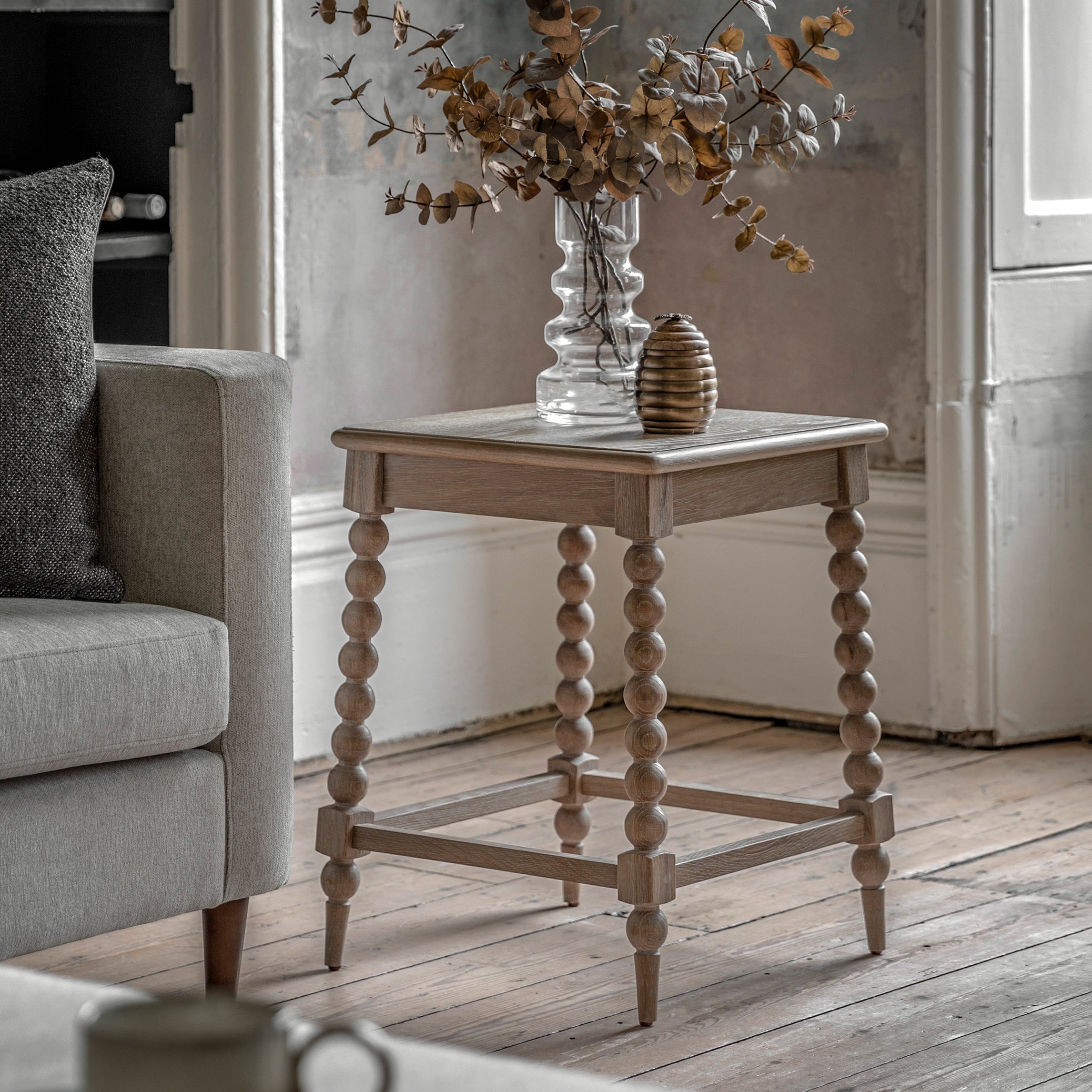 Oak side table in lime wash finish and hancrafted bobbing detailed legs