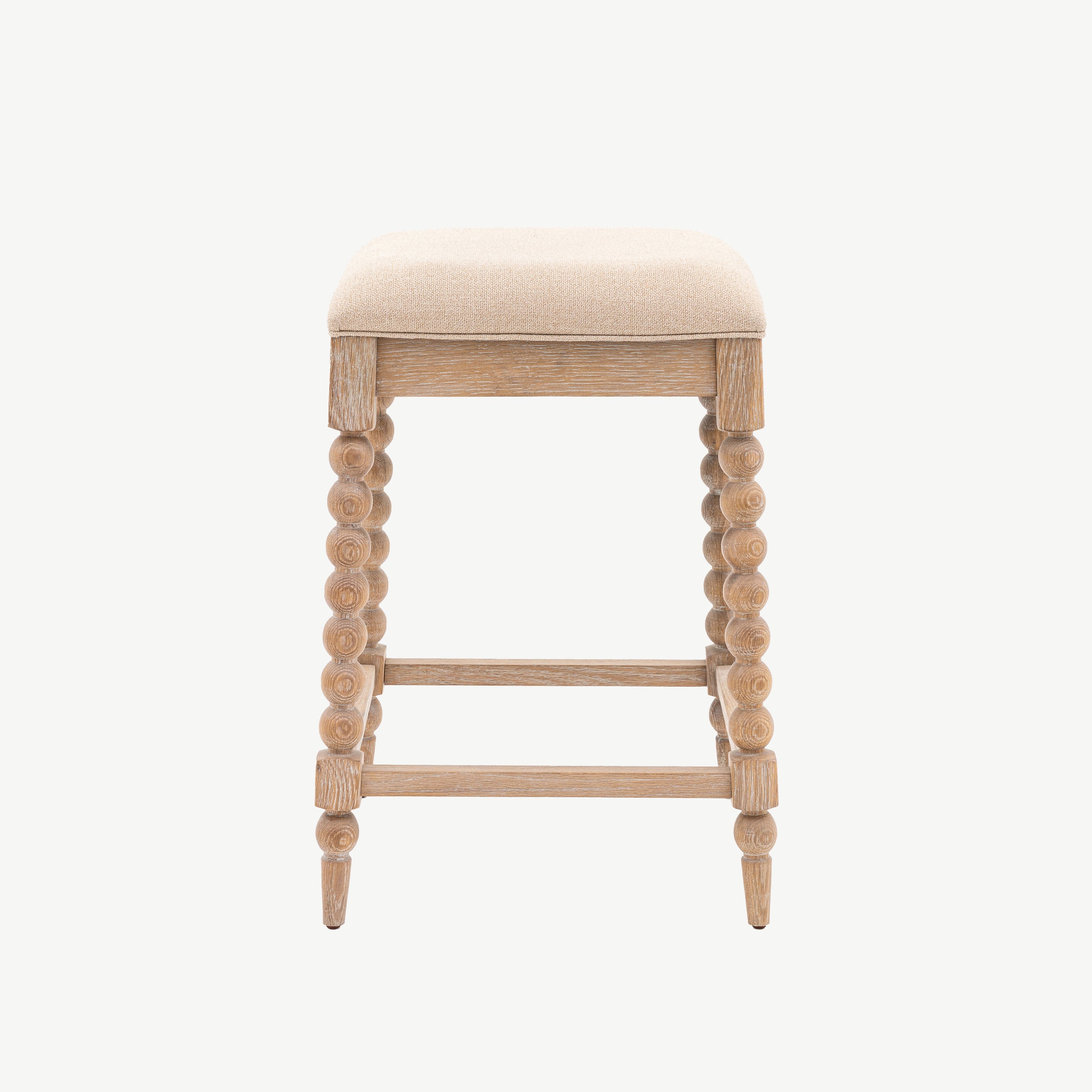 Oak small barstool in lime wash finish, handcrafted bobbing detailed legs and upholstered neutral fabric seat