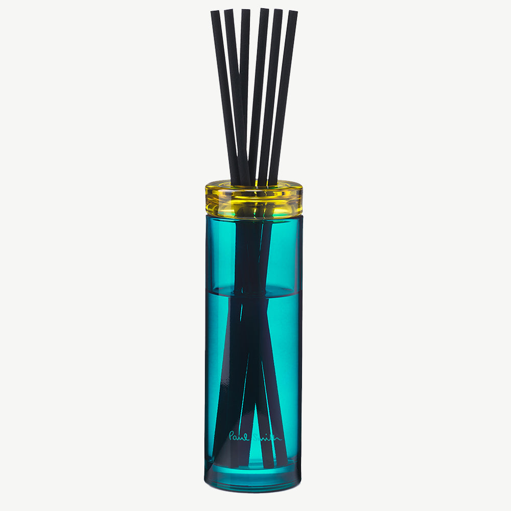 Paul Smith Sunseeker Diffuser housed in tinted turquoise glass vessel and contrasting collar with black diffuser reeds