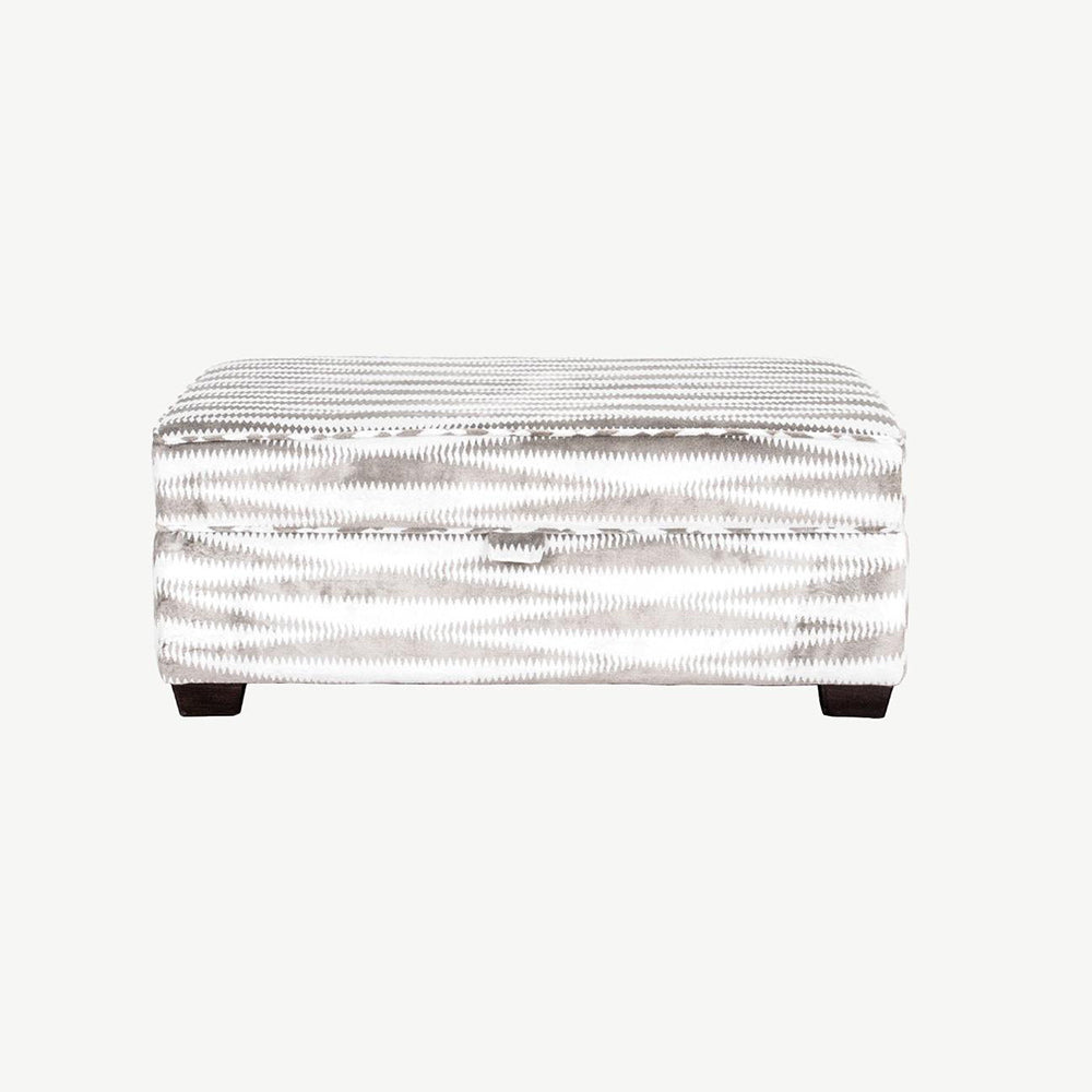 Sirius large footstool upholstered in zigzag white and black fabric with dark legs