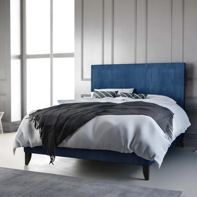 Platform bedframe upholstered in blue fabric