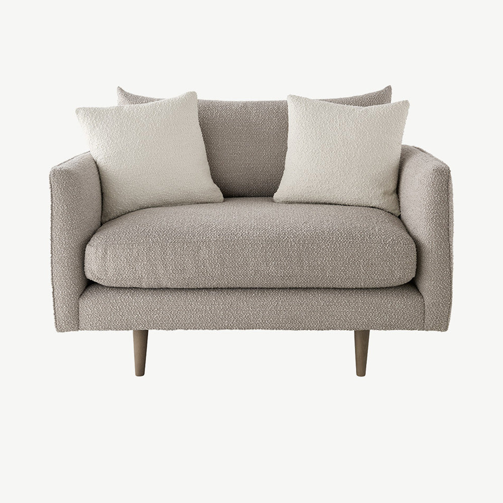 Modern snuggler chair in monza mink boucle fabric