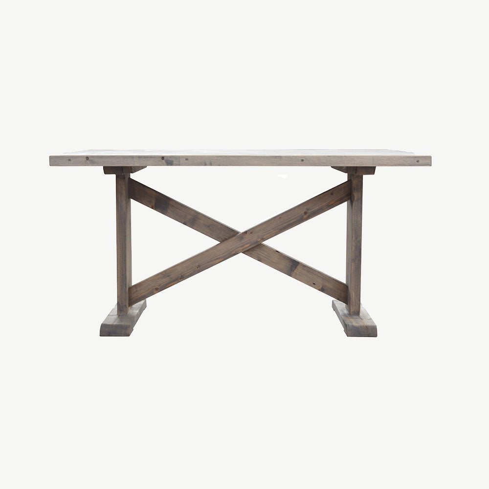 Reclaimed timber dining table in natural finish with two solid legs connected by crossbar of wood