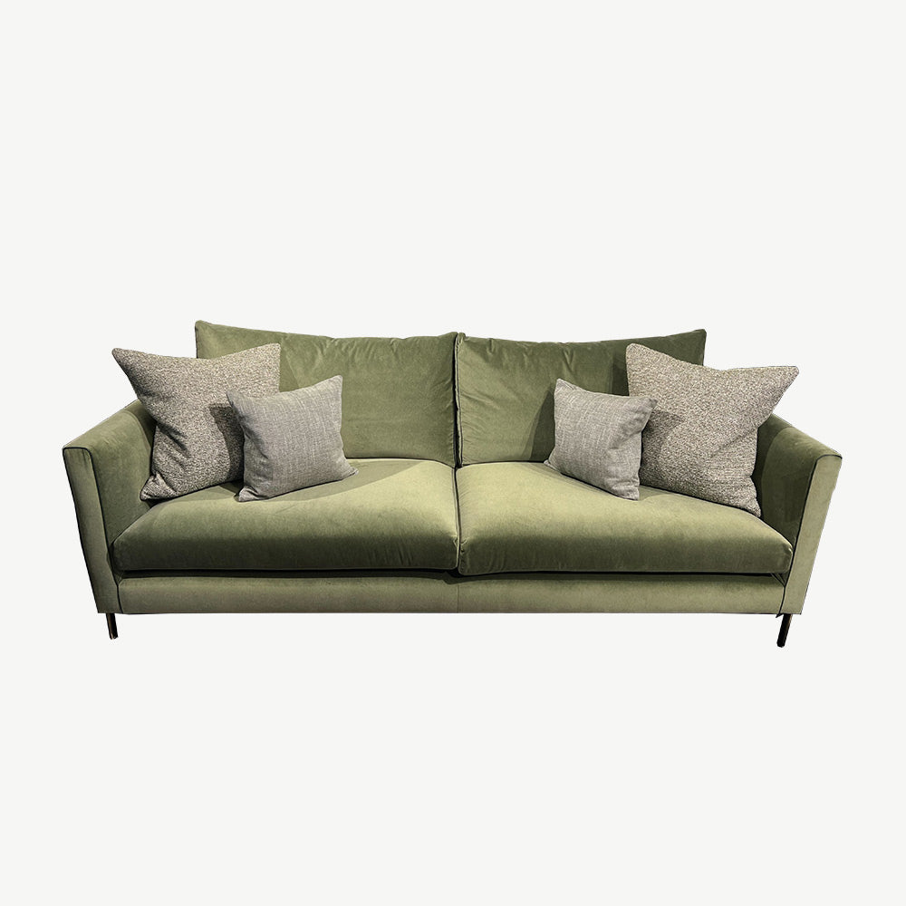 Light green sofa in upholstered fabric with leather micro piping on arm fronts