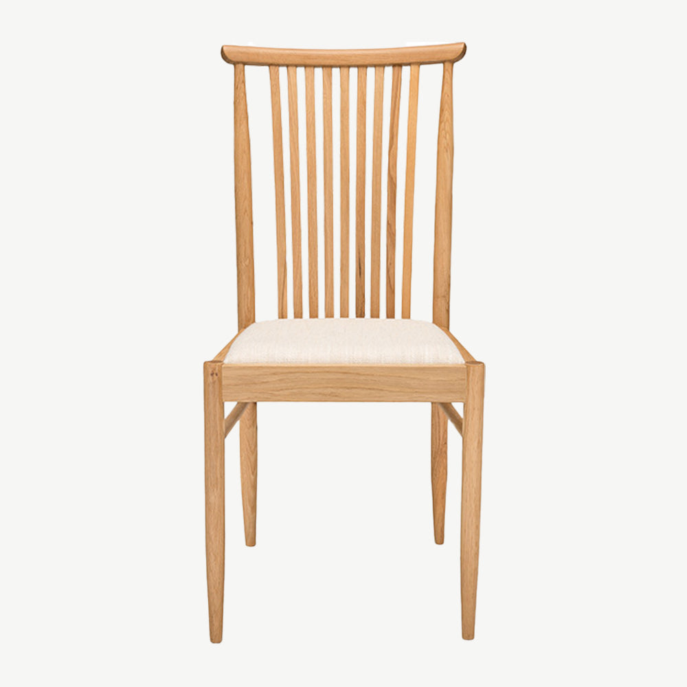 Ercol Teramo dining chair in pale oak finish with slatted back and upholstered fabric seat