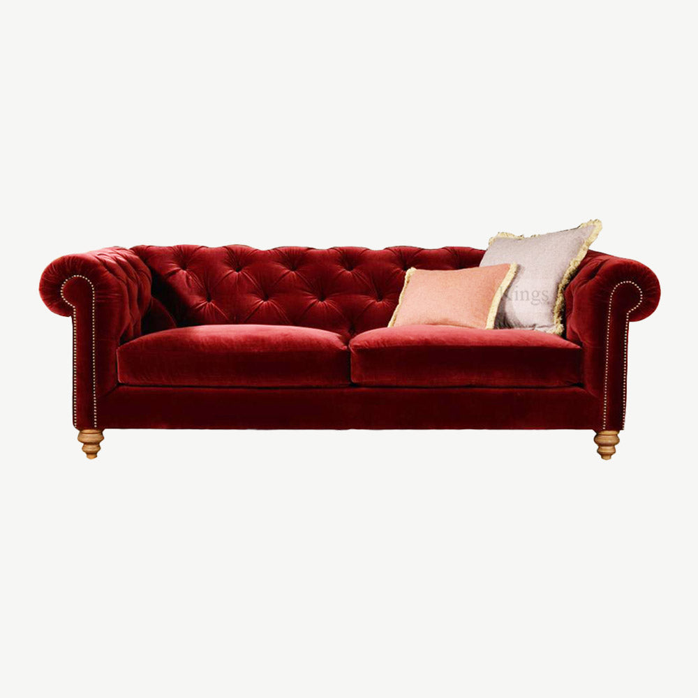 Dark red velvet sofa with button detailing and turned wooden feet