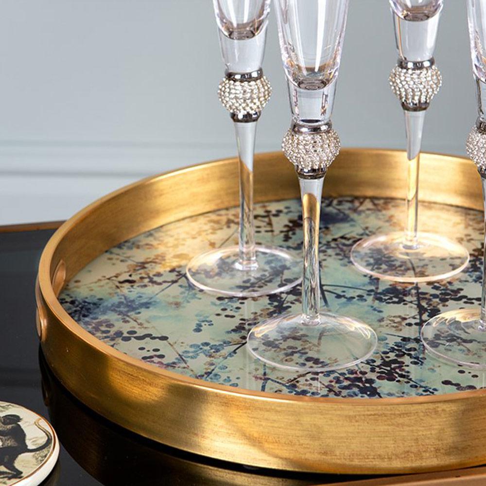 Gold look decorative tray with blossom pattern base and handle holes