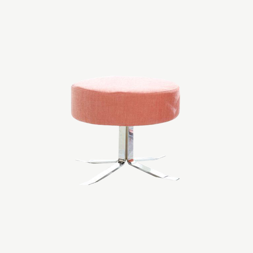 Pink fabric footstool on shiny metal stem leg