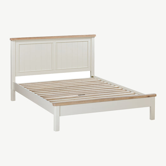 Painted off-white bedframe with natural wood accents 
