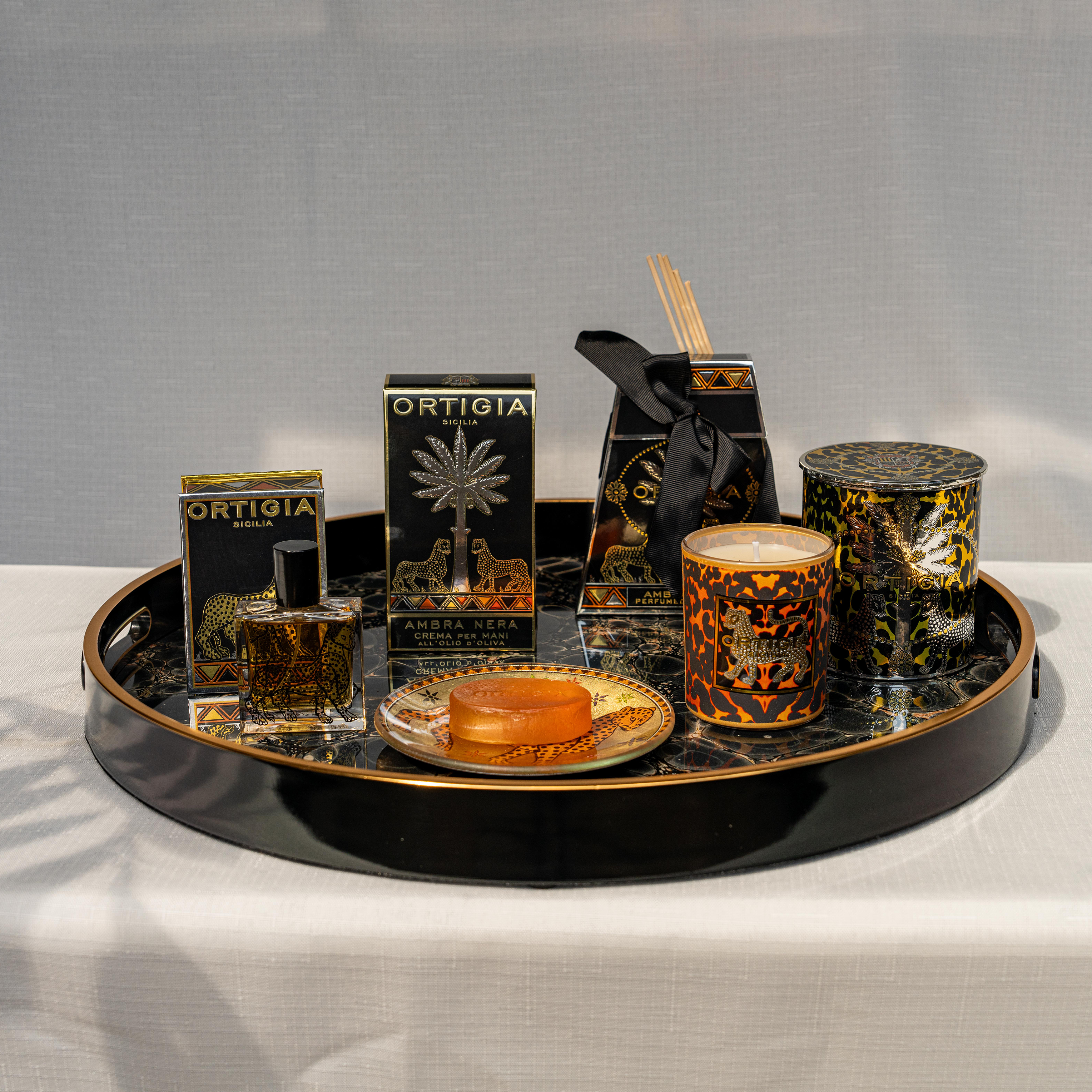 Ortigia amber diffuser in signature yellow tinted bottle with accompanying diffuser sticks