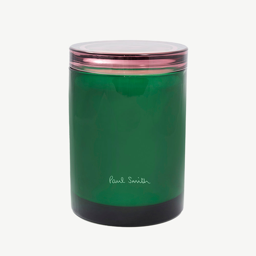 Paul Smith Botanist Scented Candle housed in tinted green glass vessel with contrasting collar that doubles as a coaster