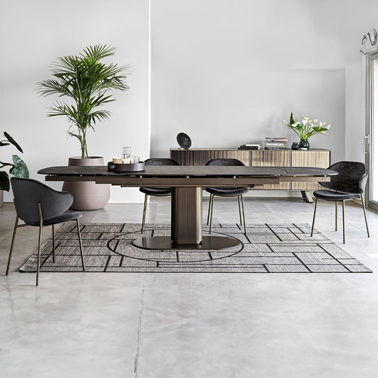 Black marble top extending dining table with matt bronze frame and floor plate

