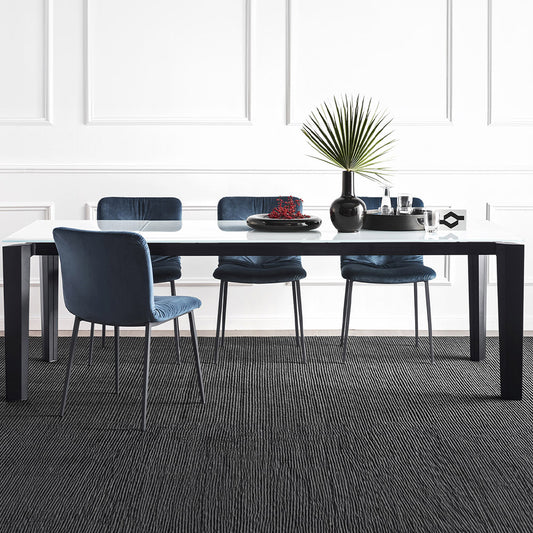 Cement top extending dining table with black legs
