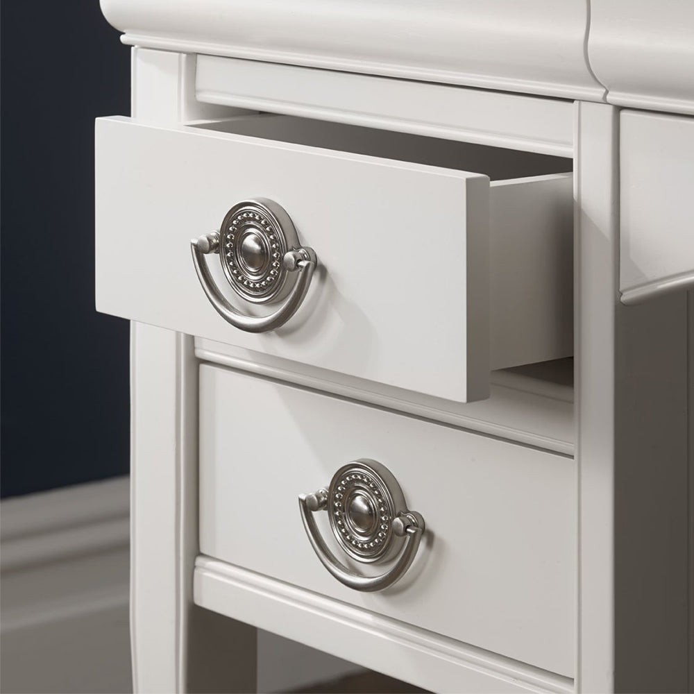 Wooden dressing table in painted white finish with silver handles and four drawers