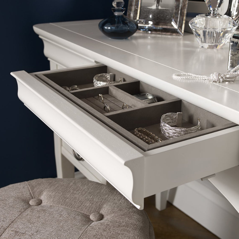 Wooden dressing table in painted white finish with silver handles and four drawers