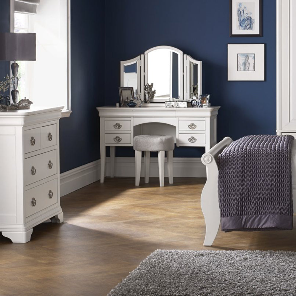 Wooden dressing table in painted white finish with silver handles and four drawers