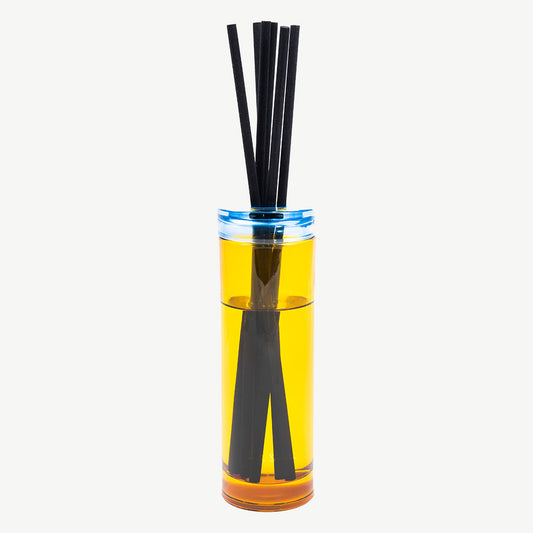 Paul Smith Daydreamer Diffuser housed in tinted yellow glass vessel and contrasting collar with black diffuser reeds