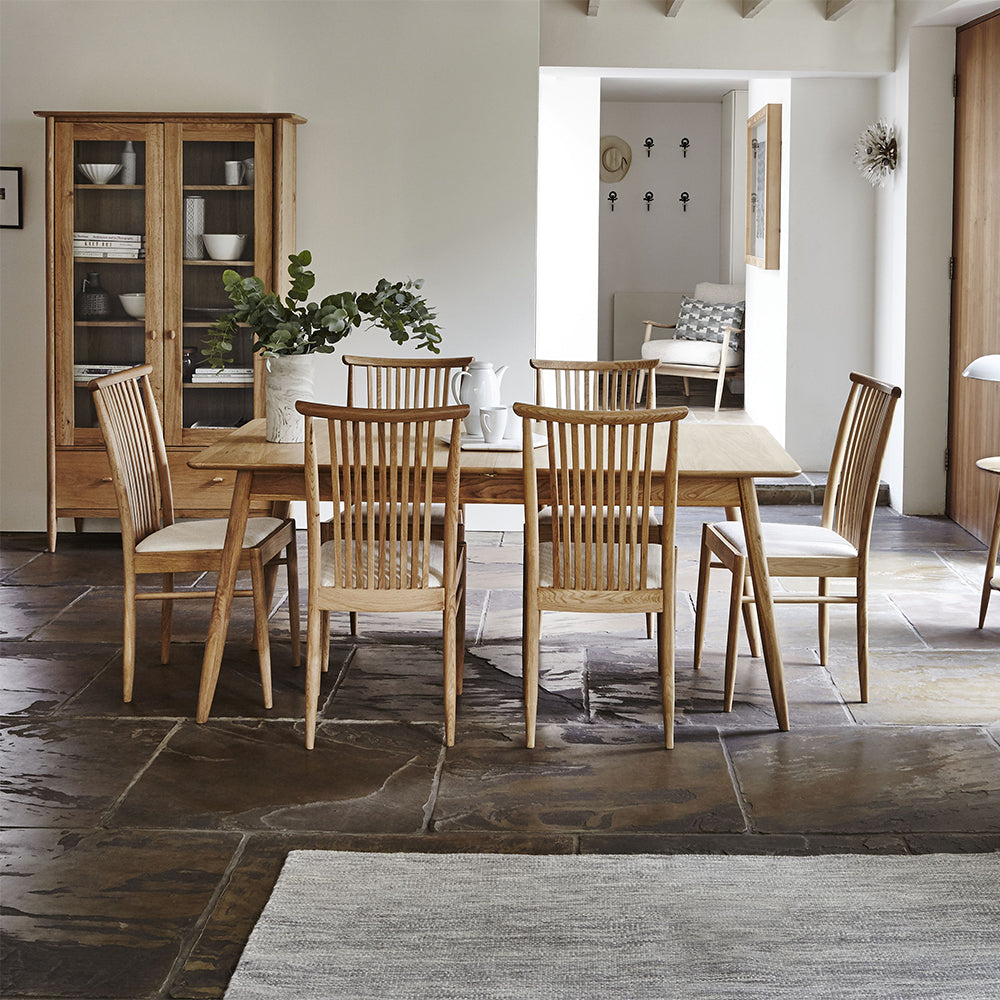 Ercol Teramo dining chair in pale oak finish with slatted back and upholstered fabric seat
