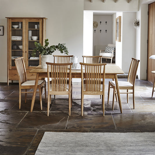 Ercol Teramo dining chair in pale oak finish with slatted back and upholstered fabric seat
