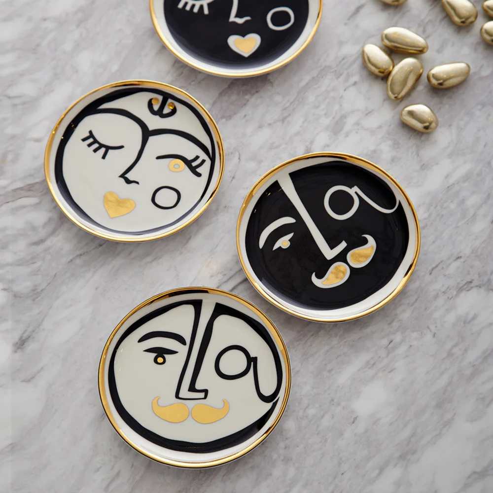 Solid brass coasters atop sleek marble base