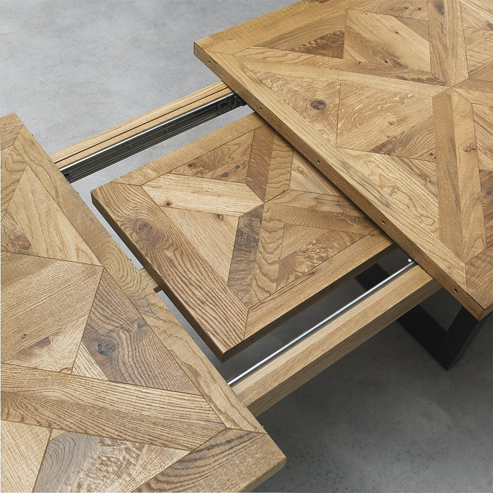 Oak veneer extending dining table with black powder coated metal base

