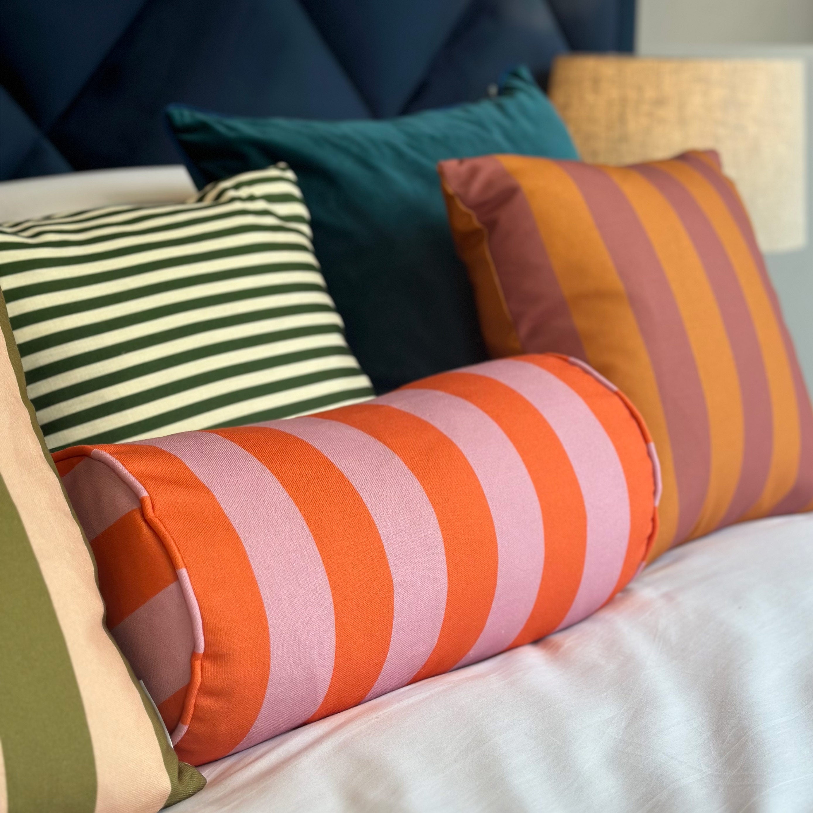 Orange and pink striped bolster cushion