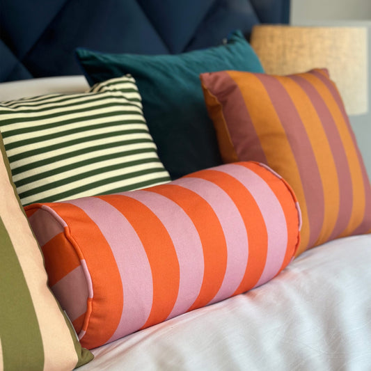 Orange and pink striped bolster cushion