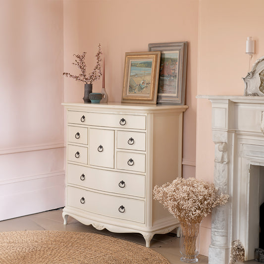 French inspired wooden 8 drawer chest in cream finish with eleven antique bronze handles 
