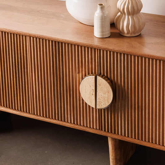 Fluted mango wood tv unit with inset handles and travertine stone top
