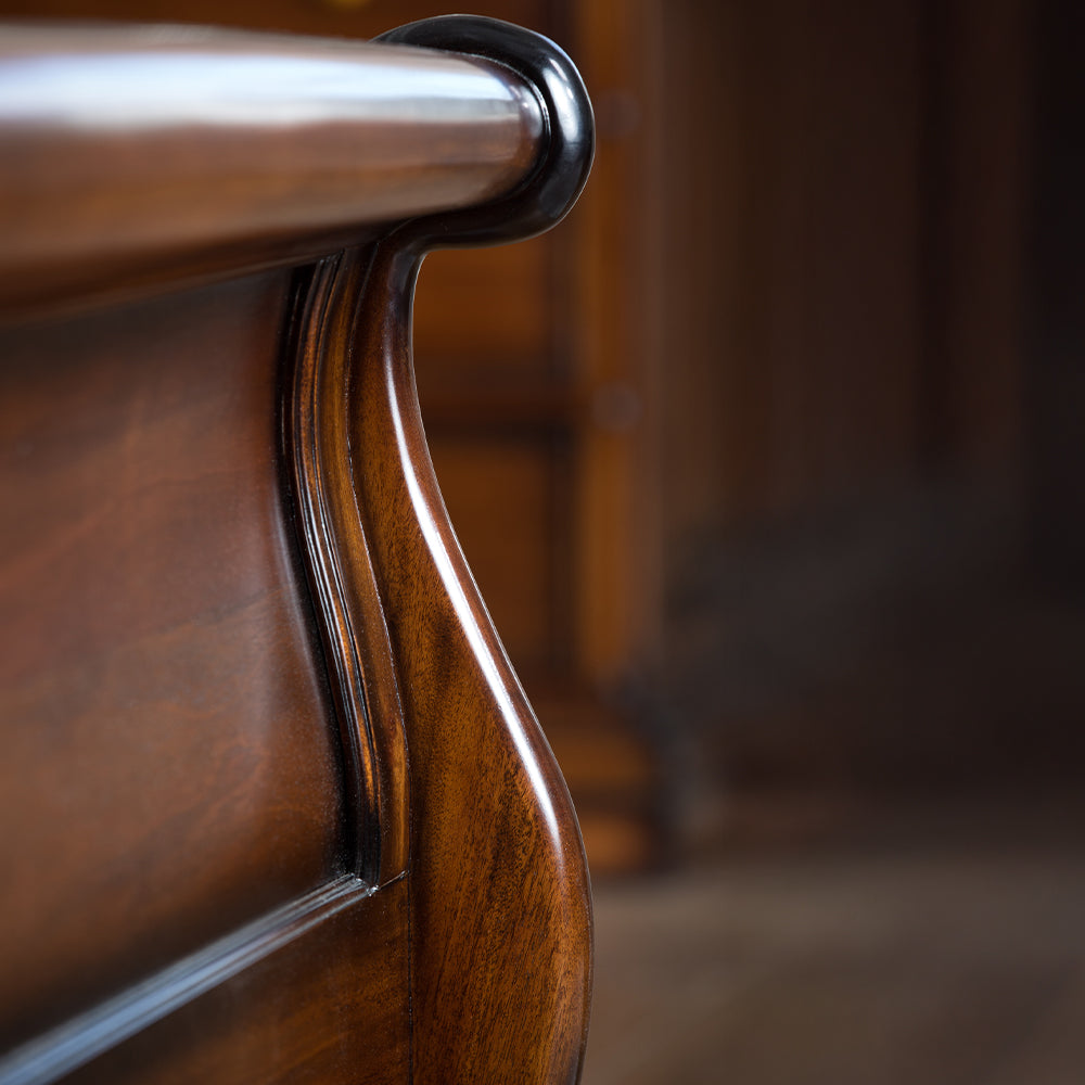 Close-up of a wooden chair with a blurred background