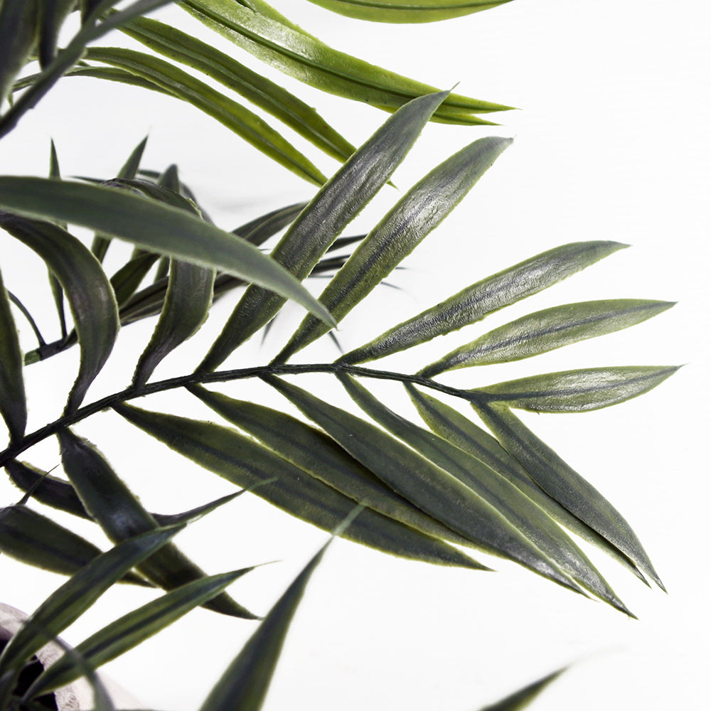 Artificial mini palm in neutral pot