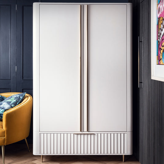 Mahogany double wardrobe in neutral ivroy finish with corrugated bottom drawer and and gold accent handles