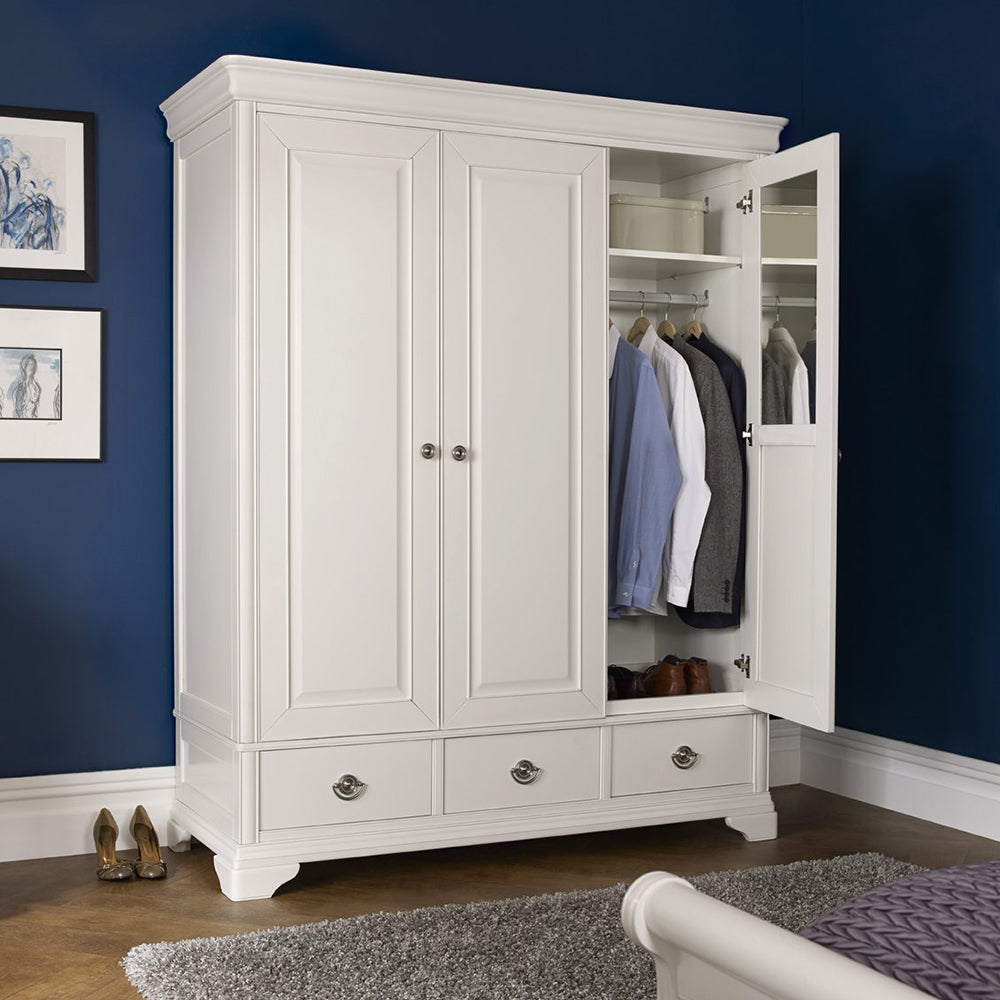 Wooden triple wardrobe in painted white finish with three accompanying bottom drawers and silver handles
