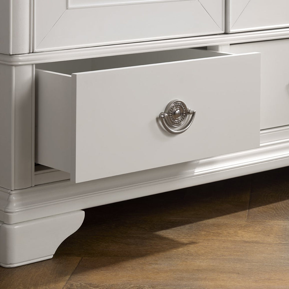 Wooden triple wardrobe in painted white finish with three accompanying bottom drawers and silver handles
